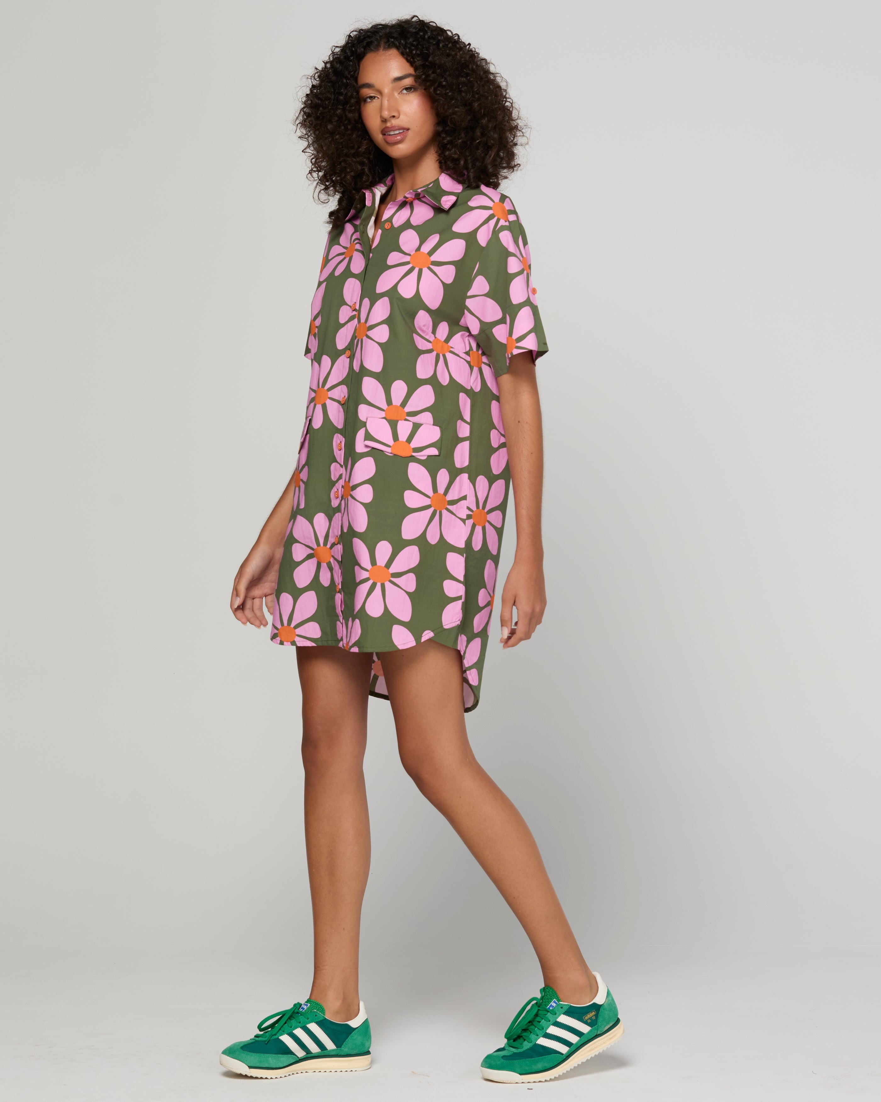 Woman wearing a green and pink floral dress 