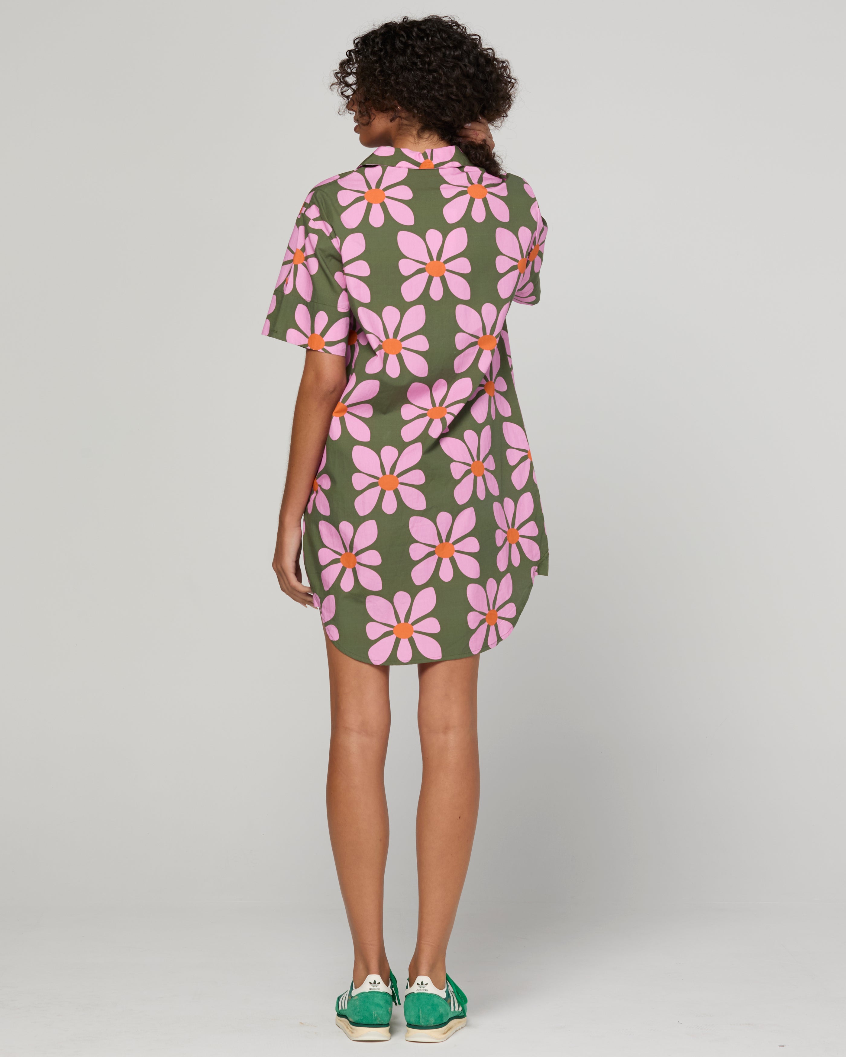 Woman wearing a floral dress with a plain background