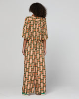 Woman wearing a patterned set in orange and green colors