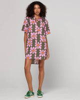 Woman wearing a floral dress with a plain background